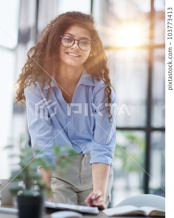 woman makes a report in the office. Woman writing notes for educational project in business 103773413