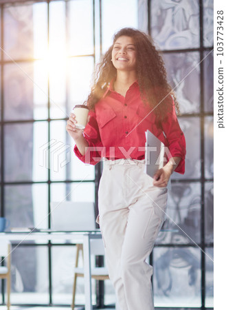 Good coffee to start a new day well. business woman in modern office 103773428