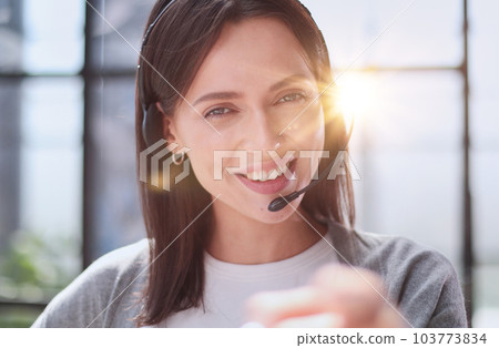 call center operator woman pointing with finger to the camera and to you, hand sign, positive and confident gesture from the front 103773834