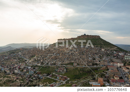 Turkey The cityscape of the old town of Mardin seen from the hill, Mardin castle standing on the mountaintop and the sunset sky Turkey The cityscape of the old town of Mardin seen from the hill, Mardin castle standing on the mountaintop and the sunset sky 103776648