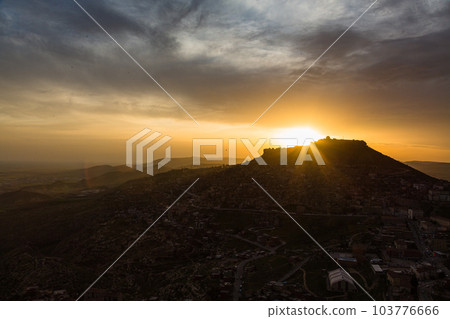 Turkey The cityscape of the old town of Mardin seen from the hill, Mardin castle standing on the mountaintop and the sunset sky Turkey The cityscape of the old town of Mardin seen from the hill, Mardin castle standing on the mountaintop and the sunset sky 103776666