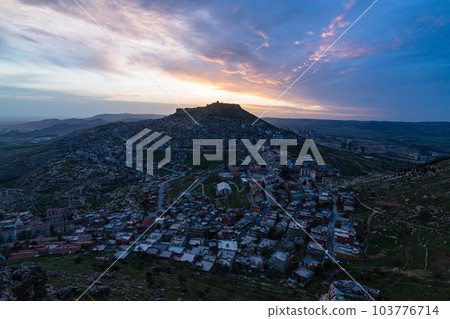 Turkey: The cityscape of Mardin's old town at dusk, Mardin Castle standing on the top of the mountain, and the sunset sky Turkey: The cityscape of Mardin's old town at dusk, Mardin Castle standing on the top of the mountain, and the sunset sky 103776714