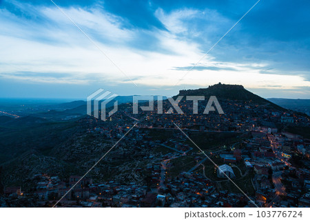 Turkey The townscape of Mardin's old town spread out on the slopes of the mountain at dusk and Mardin Castle standing on the top of the mountain Turkey The townscape of Mardin's old town spread out on the slopes of the mountain at dusk and Mardin Castle standing on the top of the mountain 103776724