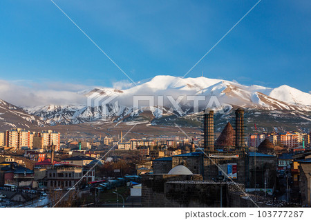 The cityscape, Chifte Minare and Palandken Mountain seen from Erzurum Castle in Erzurum, Turkey The cityscape, Chifte Minare and Palandken Mountain seen from Erzurum Castle in Erzurum, Turkey 103777287