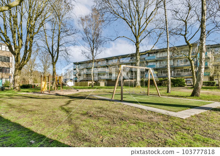 an apartment complex with playgrounds and trees in the foregrounding area at parkview apartments, south london an apartment complex with playgrounds and trees in the foregrounding area at parkview apartments, south london 103777818