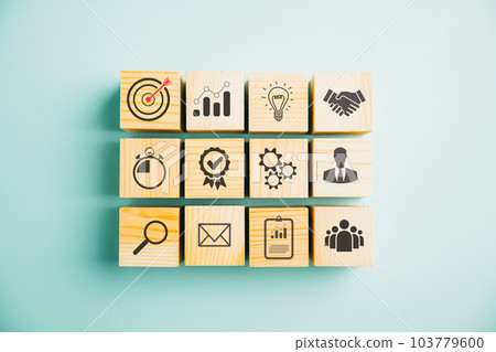 Wooden cube block step on a table with Action Plan, Goal, and Target icons. Success and business target concept. Project management and company strategy on a blue background. 103779600