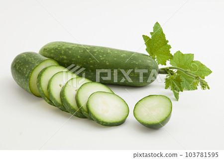 Winter melon known as wax gourd or ash gourd cut into slices and leaf decorated on a white background. Winter melon contains a high amount of vegetable oil, which is very beneficial for skin and hair 103781595