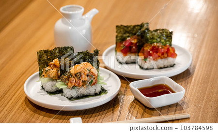 Japanese hand sushi rolls with different fish and sauce Japanese hand sushi rolls with different fish and sauce 103784598