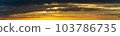 The sun's light gilds the dark storm clouds at dawn 103786735