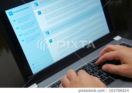 A person who chats AI on a laptop 103786824