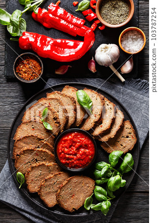 italian meatloaf cut in slices on black plate italian meatloaf cut in slices on black plate 103787254