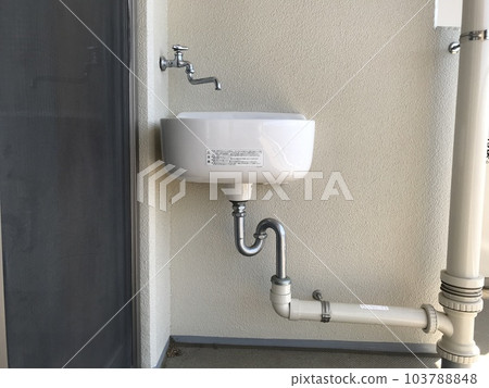 A cute slop sink installed on the balcony of an apartment building A cute slop sink installed on the balcony of an apartment building 103788848