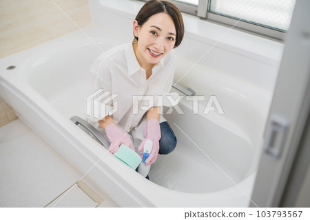 Young woman washing the bath tub Lifestyle image Young woman washing the bath tub Lifestyle image 103793567