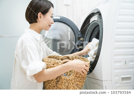 Young woman doing laundry Lifestyle image Young woman doing laundry Lifestyle image 103793584