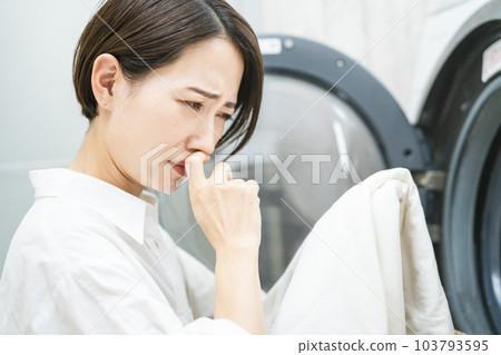 Young woman doing laundry Lifestyle image 103793595