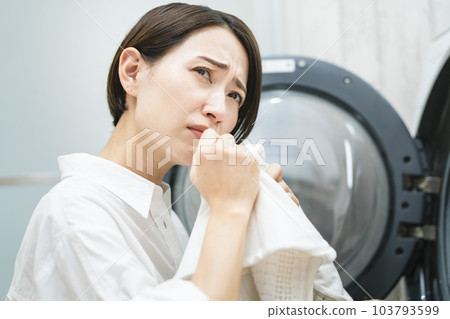 Young woman doing laundry Lifestyle image Young woman doing laundry Lifestyle image 103793599