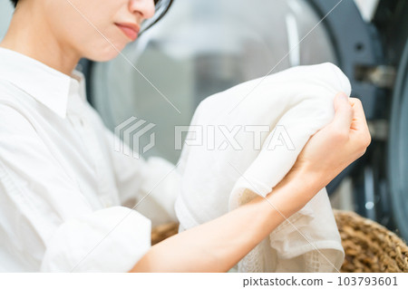 Young woman doing laundry Lifestyle image 103793601