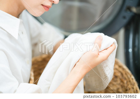 Young woman doing laundry Lifestyle image 103793602