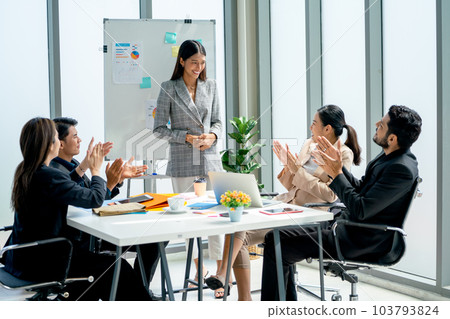 Asian business woman stand in front white board to present the project for co-workers and manager Asian business woman stand in front white board to present the project for co-workers and manager 103793824