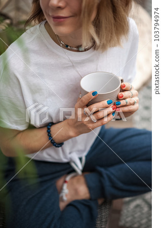 Attractive woman sitting pensively and lonely with cup of tea close up and copy space. Selective focus Attractive woman sitting pensively and lonely with cup of tea close up and copy space. Selective focus 103794974