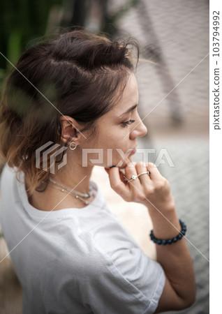 Attractive woman sitting pensively and lonely close up and copy space. Selective focus Attractive woman sitting pensively and lonely close up and copy space. Selective focus 103794992