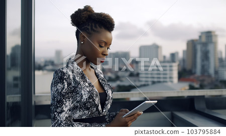 A stylish and confident African-American woman, standing on a rooftop terrace - generative AI, AI generated 103795884