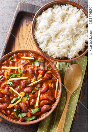 Rajma masala Red Kidney beans curry served with Basmati rice close-up on a wooden tray. Vertical top view 103796204