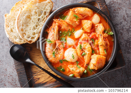 Mediterranean soup of seafood and white fish with shrimp, mussels, scallops, squid close-up in a bowl. horizontal top view Mediterranean soup of seafood and white fish with shrimp, mussels, scallops, squid close-up in a bowl. horizontal top view 103796214