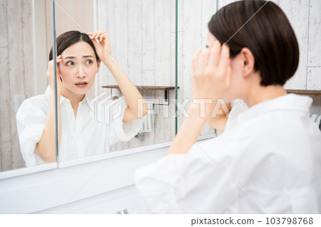 Beauty image of a young woman doing hair care Beauty image of a young woman doing hair care 103798768