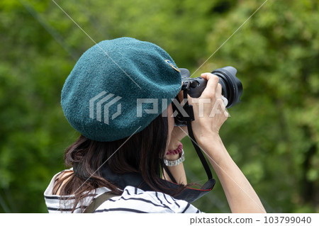 A woman taking a picture 103799040