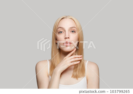 Young female face. Attractive blonde woman with clear skin. Facial treatment, skincare  103799265