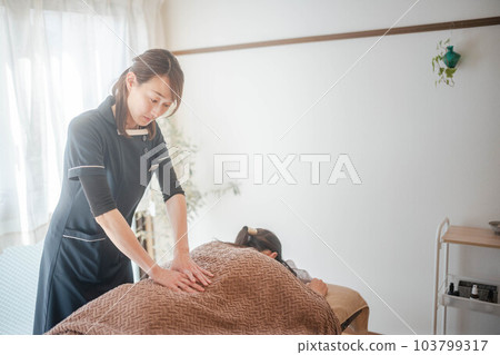 Woman doing female relaxation massage Woman doing female relaxation massage 103799317