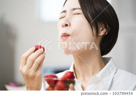 Young woman eating strawberries Eating and drinking image 103799454