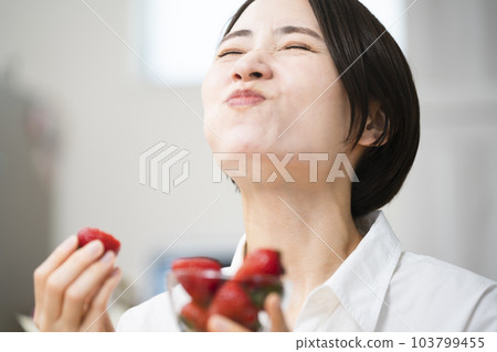 Young woman eating strawberries Eating and drinking image 103799455