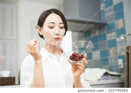 Young woman eating cherries Eating and drinking image 103799469