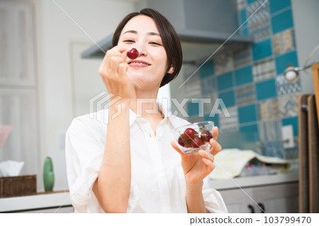 Young woman eating cherries Eating and drinking image 103799470