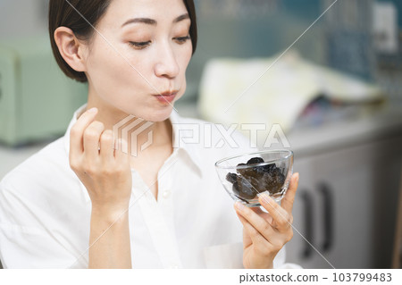 Young woman eating prune Food and drink image 103799483