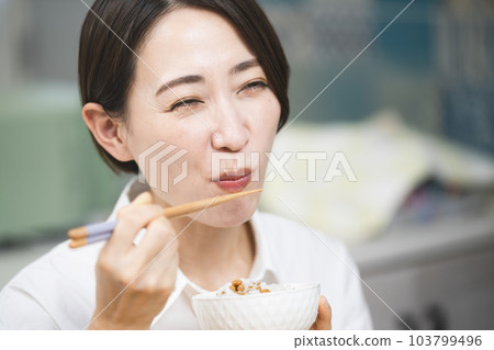 Young woman eating natto rice Food and drink image 103799496