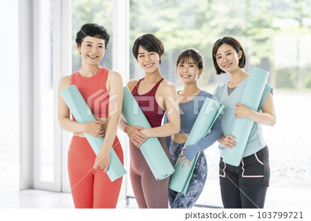 Four women with yoga mats 103799721