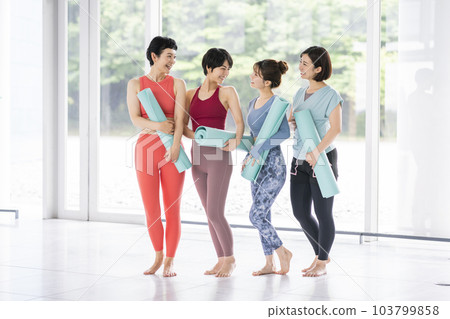 Four women with yoga mats Four women with yoga mats 103799858