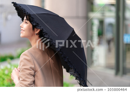 A woman holding a parasol A woman holding a parasol 103800464