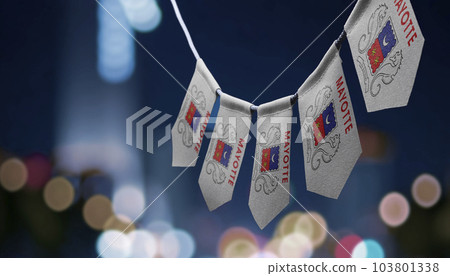 A garland of Mayotte national flags on an abstract blurred background A garland of Mayotte national flags on an abstract blurred background 103801338