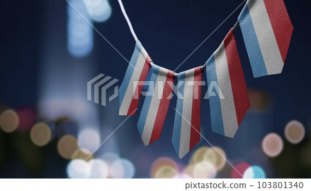 A garland of Luxembourg national flags on an abstract blurred background A garland of Luxembourg national flags on an abstract blurred background 103801340