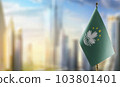 A small Macao flag on an abstract blurry background 103801401