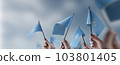 A group of people holding small flags of the International Intellectual Property Organization in their hands 103801405