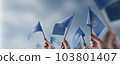 A group of people holding small flags of the World Health Organization WHO in their hands 103801407