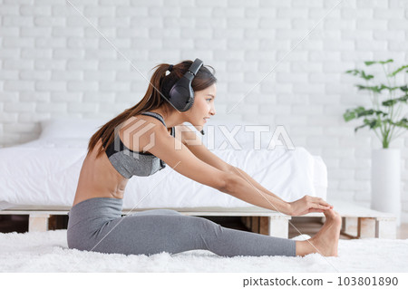 Calm of Asian woman in sportwear stretching muslce to warm up breathing and meditation with yoga at home.Healthy female doing yoga Feeling so comfortable and relax,Wellness Yoga Healthcare Concept Calm of Asian woman in sportwear stretching muslce to warm up breathing and meditation with yoga at home.Healthy female doing yoga Feeling so comfortable and relax,Wellness Yoga Healthcare Concept 103801890