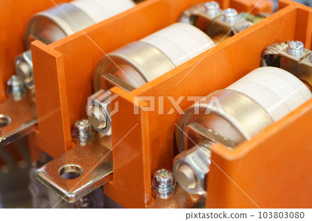 Electrical fuses installed inside an orange protective housing Electrical fuses installed inside an orange protective housing 103803080