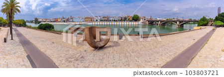 City promenade and Isabella II bridge in Seville on a sunny morning. City promenade and Isabella II bridge in Seville on a sunny morning. 103803721