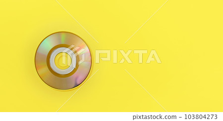 Top down view, small CD on yellow board, wide banner with space for text right. 103804273